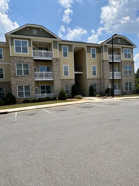 an apartment building with an empty parking lot