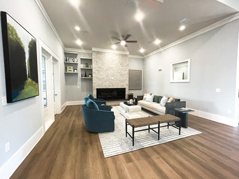 a living room with a couch and a chair and a fireplace