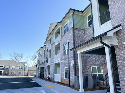 A row of townhouses with a clear blue sky above.