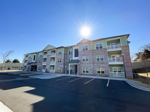 A sunny day at a multi-story apartment complex.