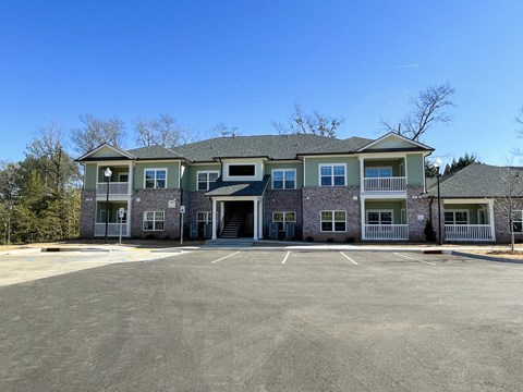 A large building with a parking lot in front.
