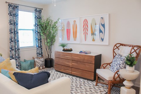 a living room with a couch and a dresser and surfboards on the wall