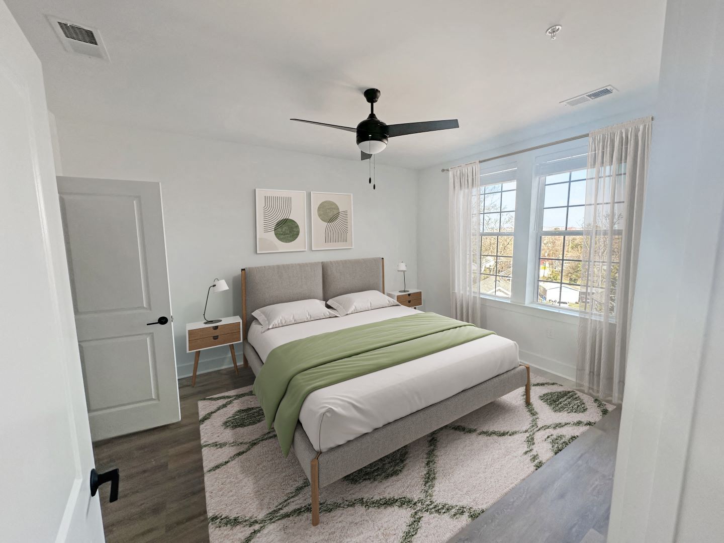 Gordon Street Lofts Bedroom with bed, rug, dresser and floor-to-ceiling curtains.