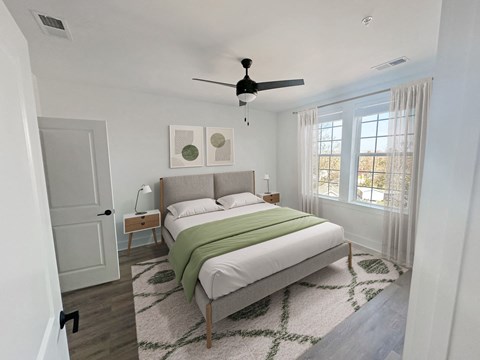 Gordon Street Lofts Bedroom with bed, rug, dresser and floor-to-ceiling curtains.
