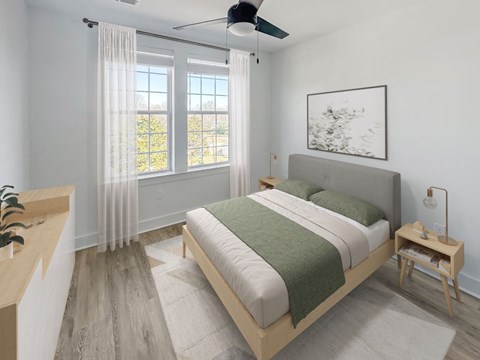 A bedroom with a large bed and a ceiling fan.
