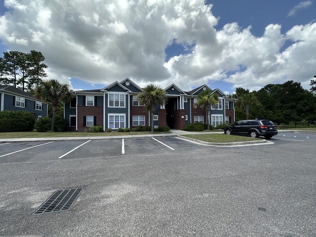 a parking lot in front of an apartment building