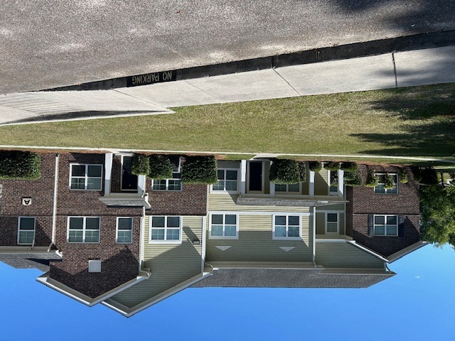 a reflection of a house in a pool of water
