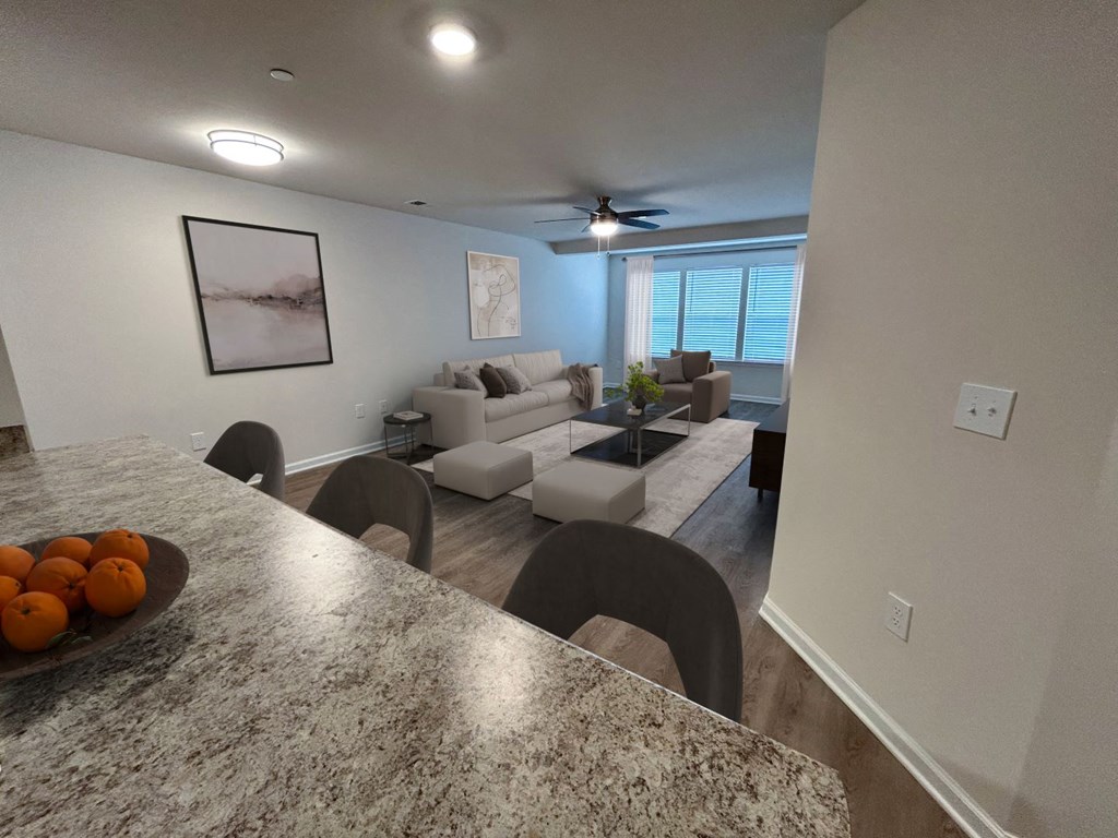A kitchen with granite countertops and a bowl of oranges on it.