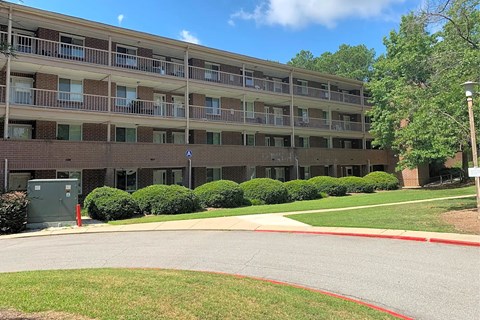 A large apartment complex with a red line painted on the road.
