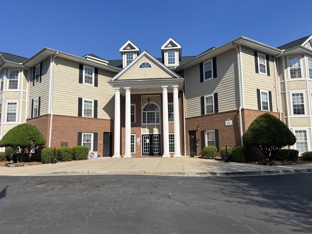 A large apartment complex with a central entrance and multiple buildings.