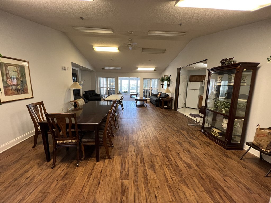A dining room with a wooden table and chairs.