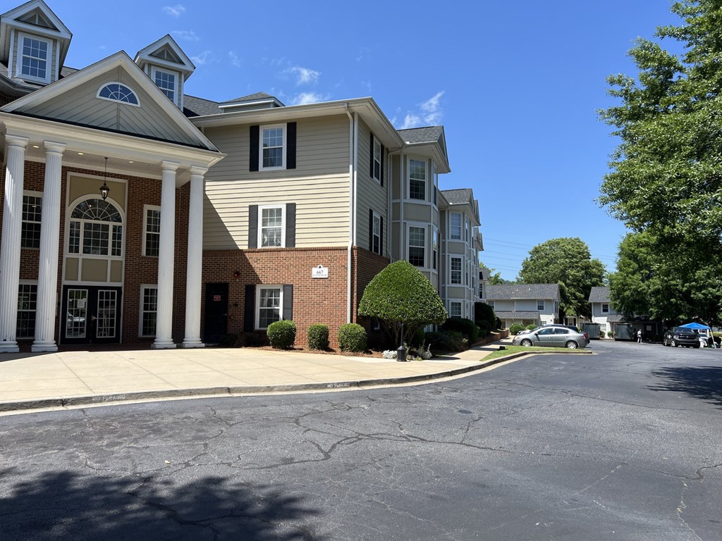 A row of townhouses with a cracked street in front.