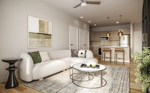 A modern living room with a white sofa and a coffee table.
