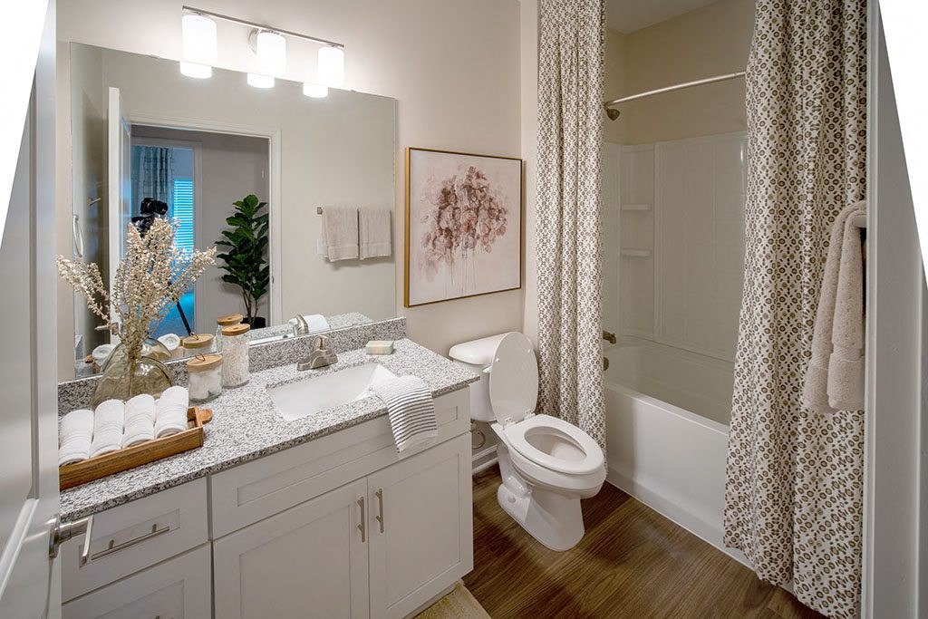 a bathroom with a shower and a sink and a toilet