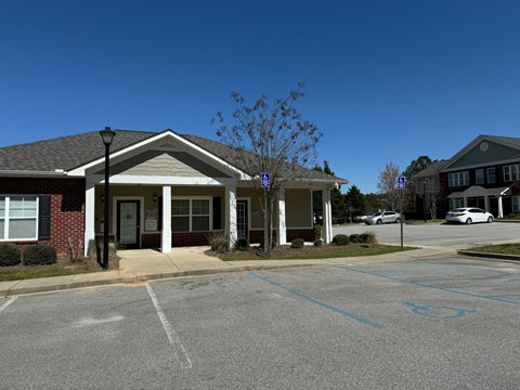 A building with a parking lot in front of it.