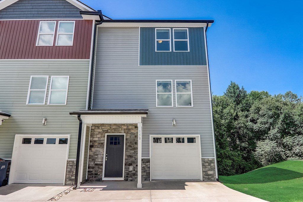 a house with two garage doors on the side of it