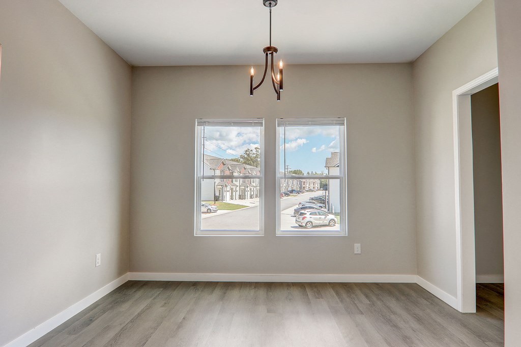 an empty living room with windows and a street view