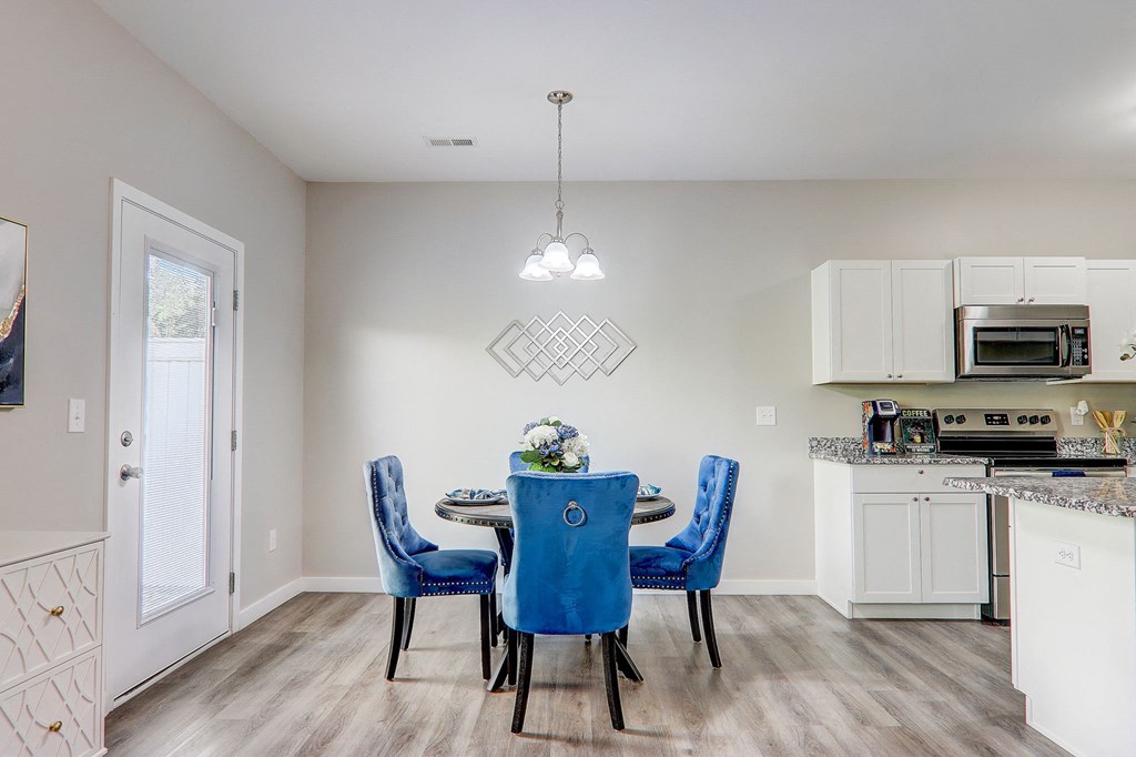 an open kitchen and dining room with a table and chairs