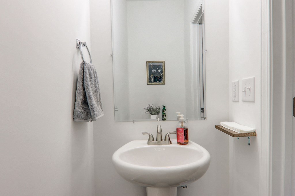 a small bathroom with a sink and a mirror