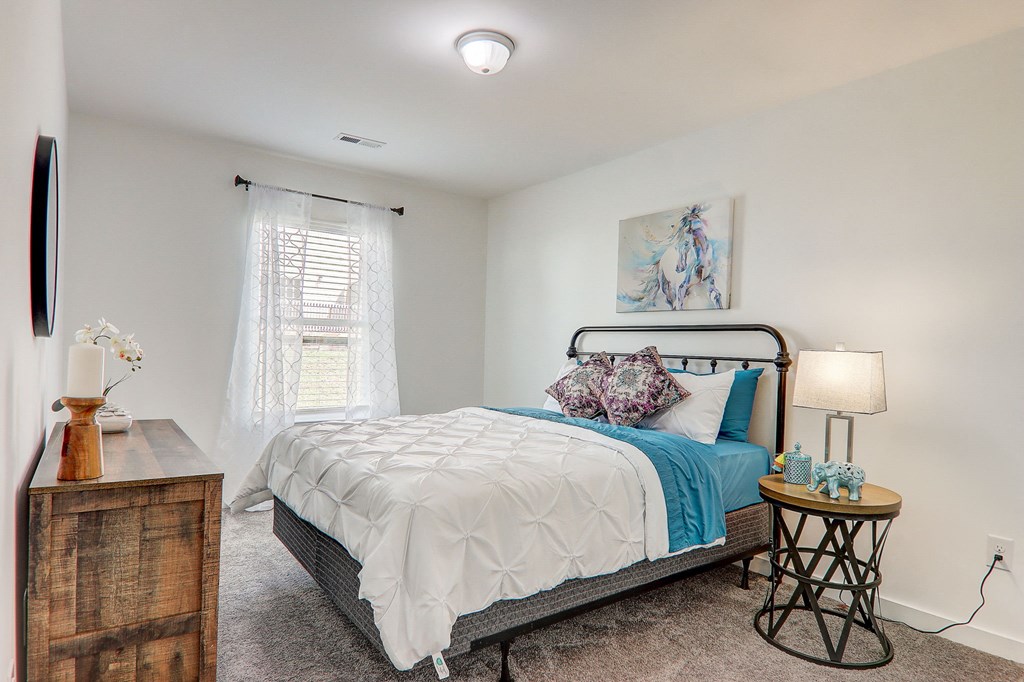 a bedroom with a bed and a window