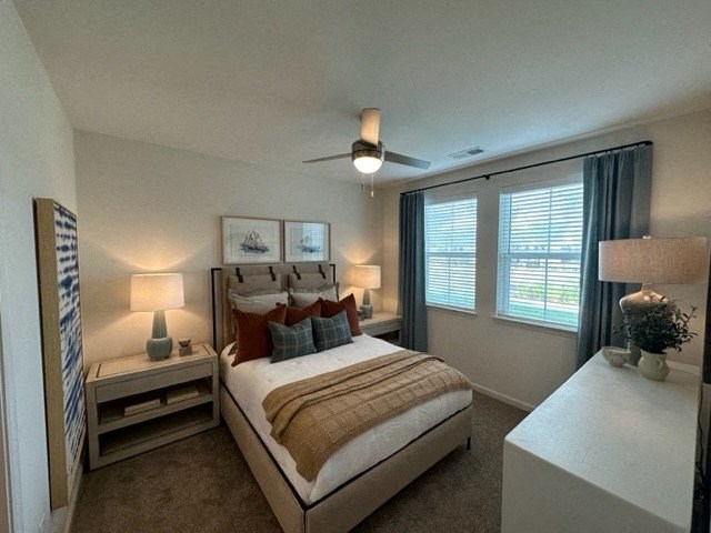 a bedroom with a bed and a ceiling fan