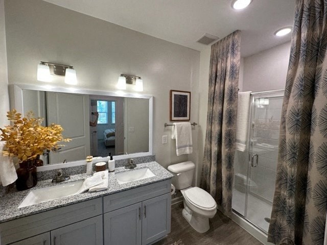 a bathroom with a toilet and a sink and a shower