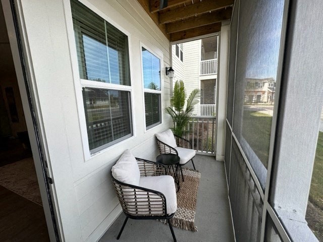 a porch with two chairs and a table on it