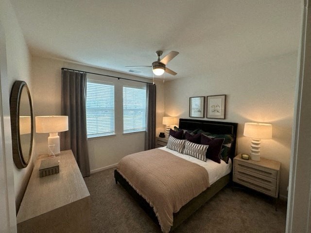 a bedroom with a bed and a ceiling fan