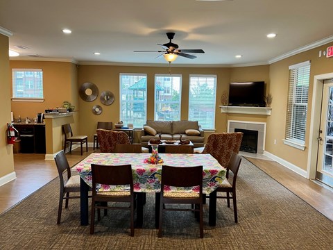 A dining room with a table set for six.