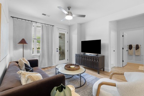 A living room with a brown couch and a dog on it.