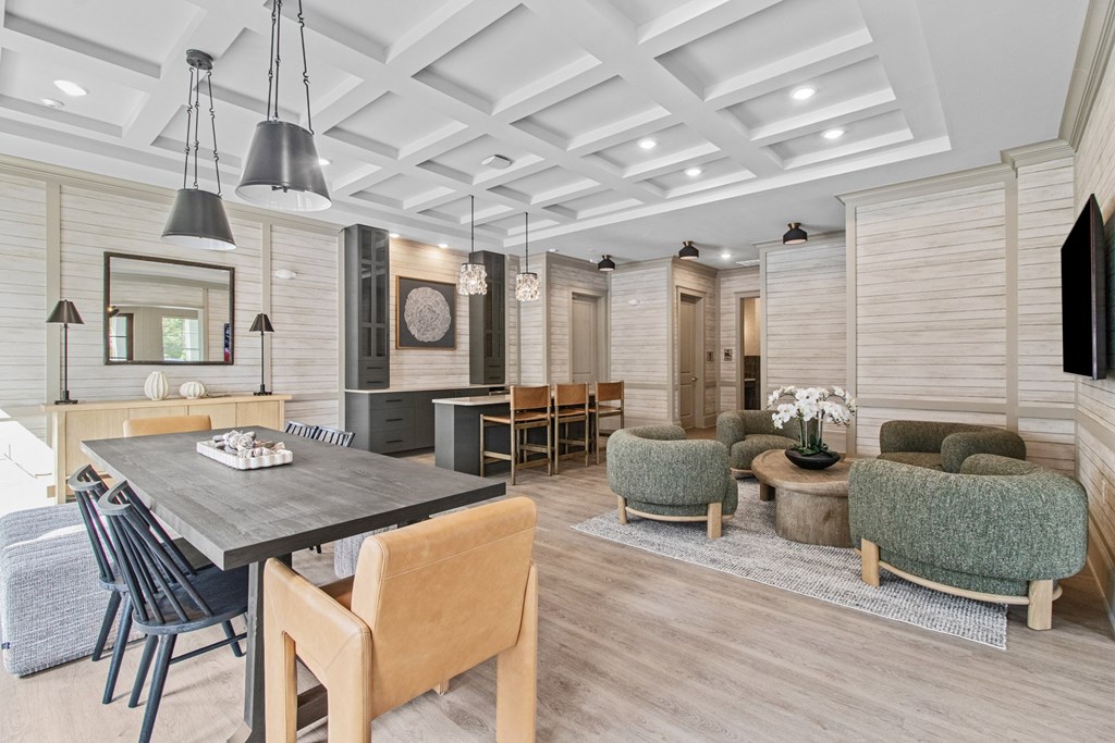 A modern dining room with a wooden table and chairs.