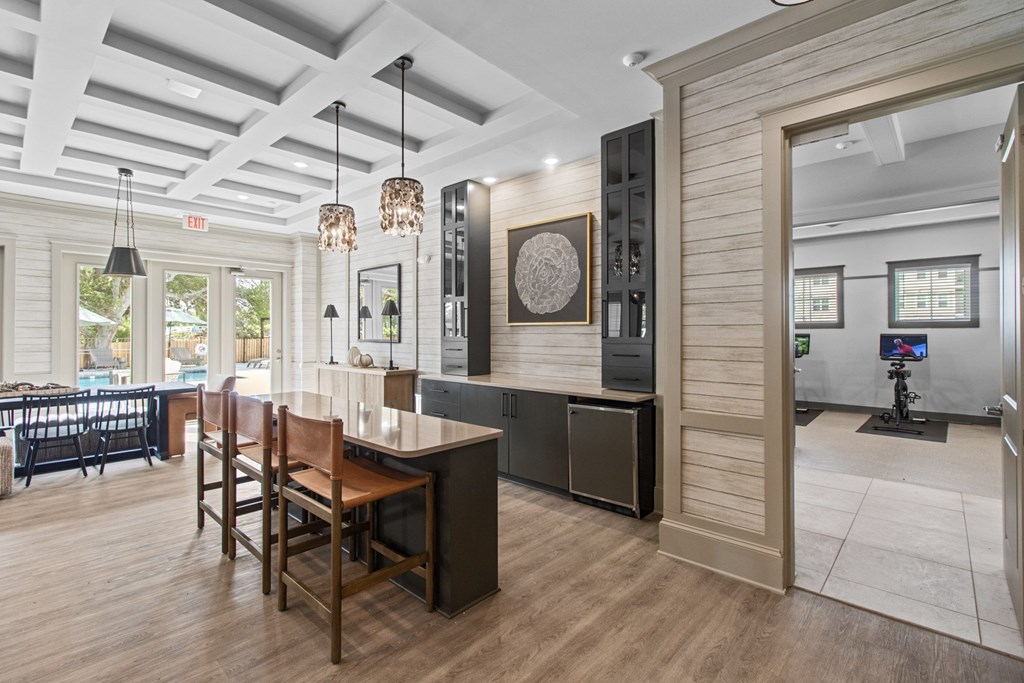 A modern kitchen with a wooden table and chairs.