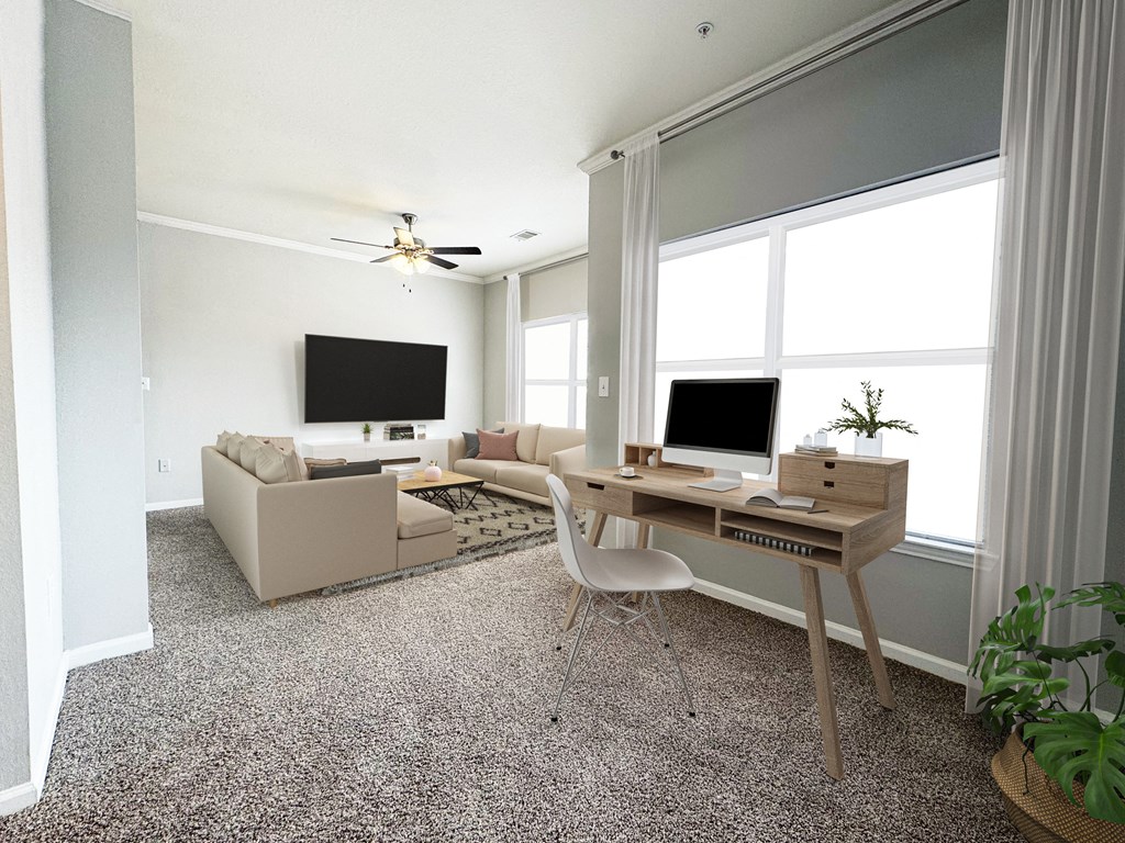 A room with a desk, a couch, and a television.