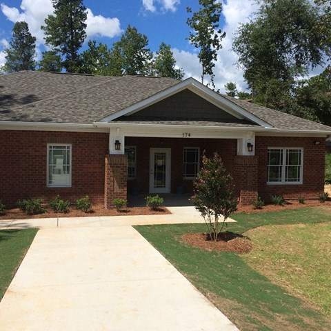 A house with a brick facade and a white door.