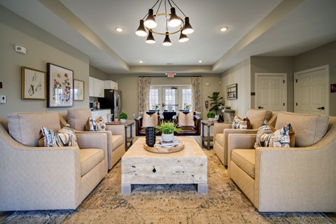 A living room with beige couches and a wooden coffee table.
