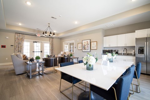 A modern dining room with a large table and chairs.