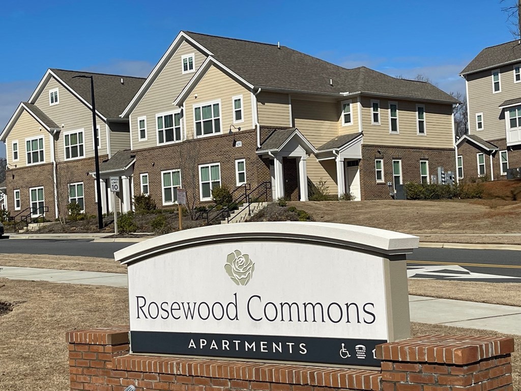 a sign in front of a row of apartment buildings