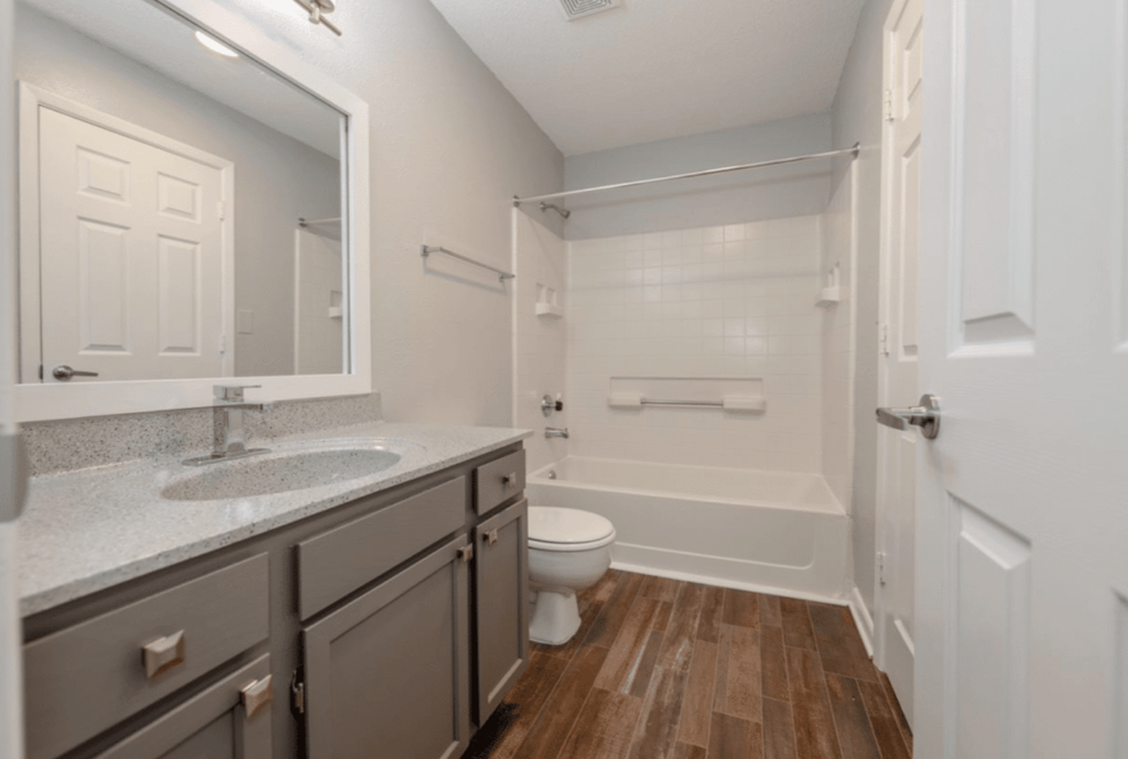 A bathroom with a toilet, sink, and bathtub.