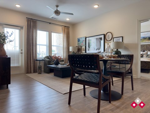 A living room with a black chair and a wooden floor.