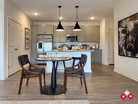 A modern kitchen with a dining table and chairs.