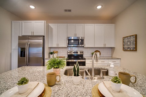 a kitchen with stainless steel appliances and granite counter tops