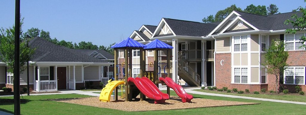 a playground in front of a group of houses