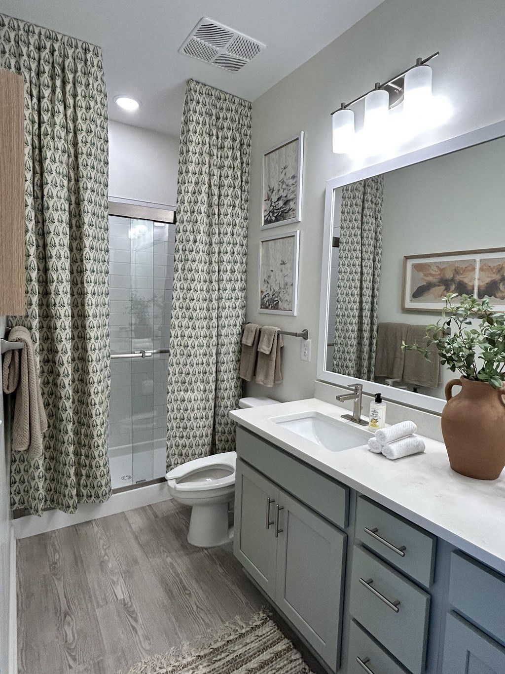 a bathroom with a sink and a shower and a toilet