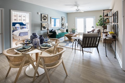 A dining room with a round table and chairs.