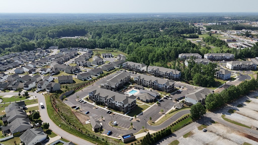 A bird's eye view of a residential complex with a swimming pool.