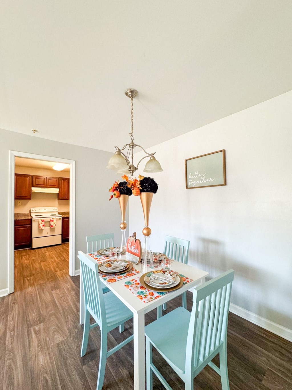 a dining room with a table and chairs and a chandelier