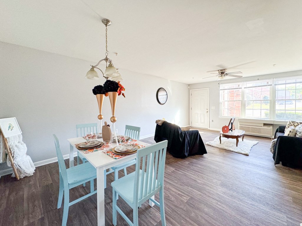 a dining room and living room with a table and chairs