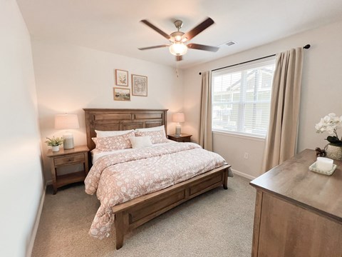 Pet-Friendly Luxury Apartments In Boiling Springs, SC - Grande At Geyser Falls - Carpeted Bedroom Featuring A Large Bed And A Ceiling Fan