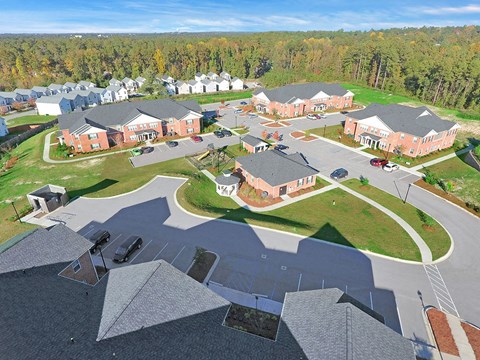 an aerial view of a neighborhood with houses and a parking lot