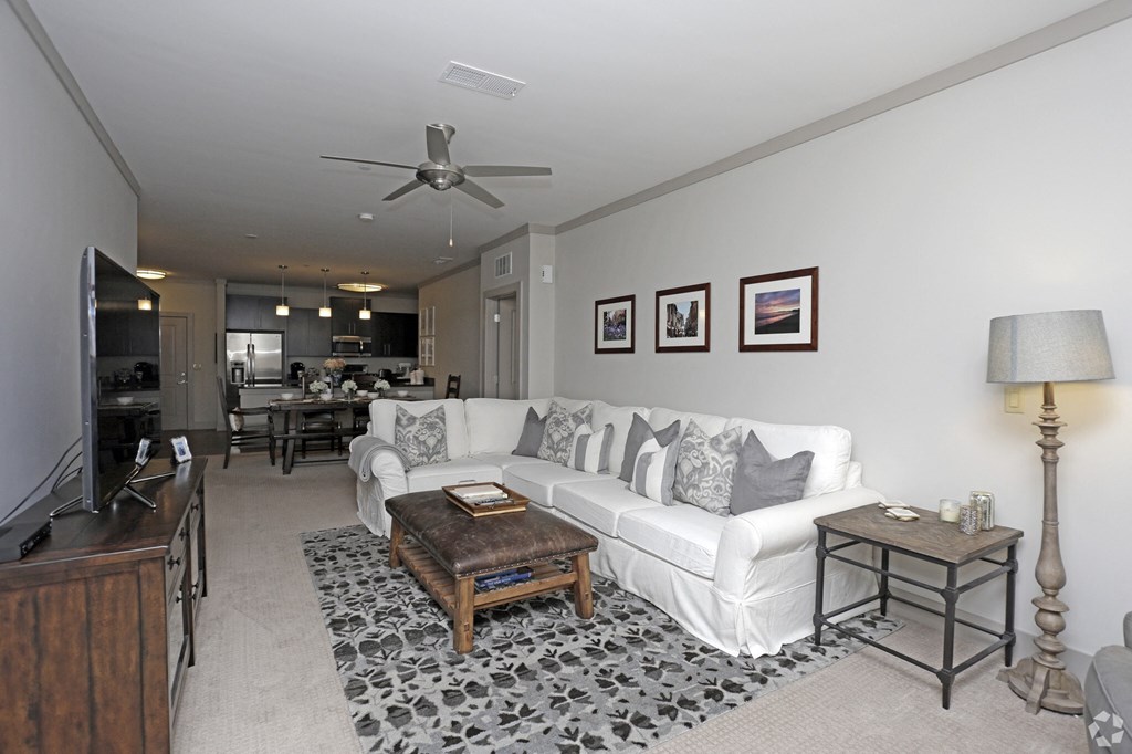 a living room with a white couch and a coffee table